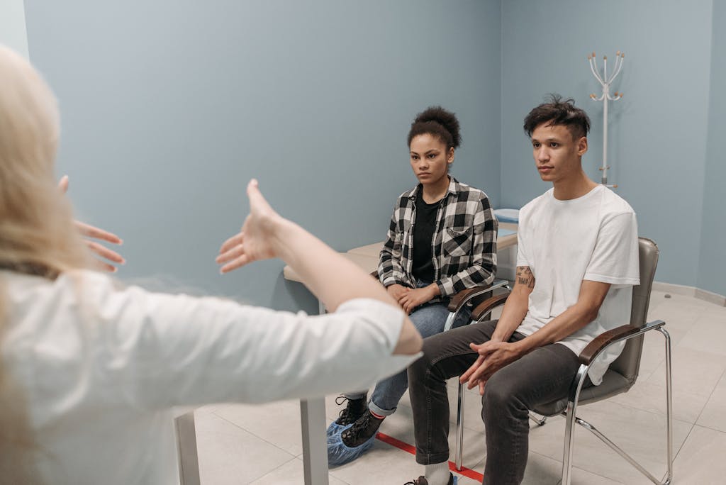 A couple engaging in a conversation during a therapy session indoors.